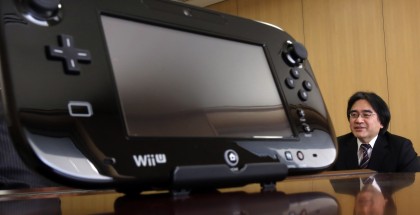 Nintendo Co's President Satoru Iwata speaks next to company's Wii U game controller during an interview with Reuters at the company headquarters in Kyoto, western Japan